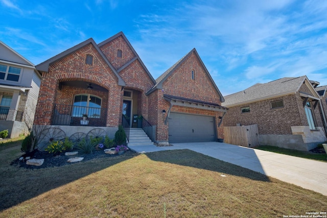 view of front of house with a front lawn, a garage, brick siding, and driveway