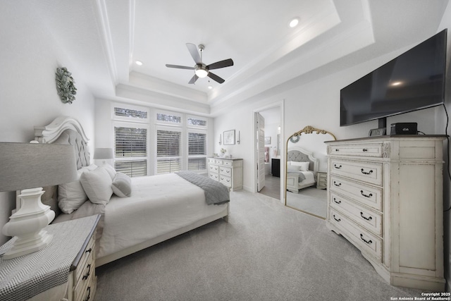 bedroom with light carpet, recessed lighting, a raised ceiling, and a ceiling fan