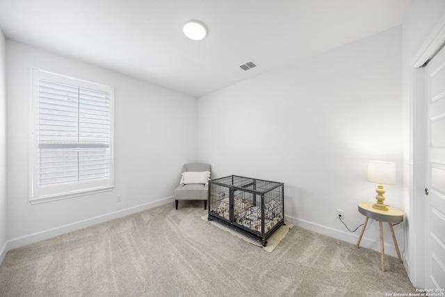 sitting room featuring visible vents, baseboards, and carpet