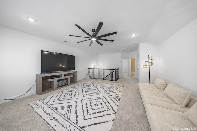 carpeted living area with baseboards, visible vents, lofted ceiling, recessed lighting, and ceiling fan