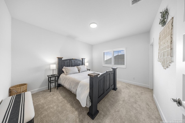 bedroom featuring visible vents, light colored carpet, and baseboards