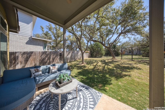 exterior space featuring a patio, outdoor lounge area, and a fenced backyard