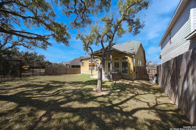 view of yard with a patio area, a gate, and a fenced backyard