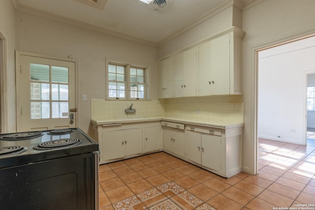 kitchen with ornamental molding, black electric range oven, backsplash, light countertops, and light tile patterned floors