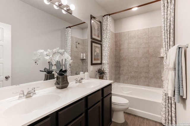 9303 Graze Land Dr, San Antonio, TX 78211 - bathroom featuring a sink, toilet, wood finished floors, and shower / tub combo