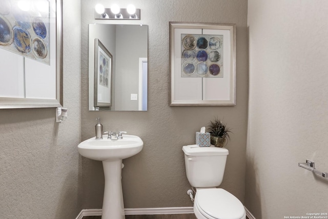 9303 Graze Land Dr, San Antonio, TX 78211 - bathroom with a textured wall and toilet