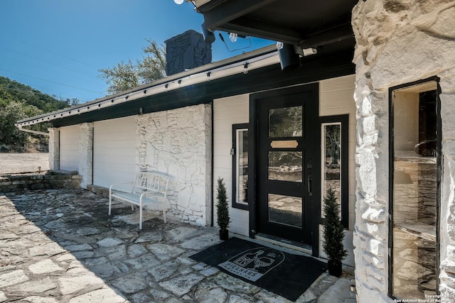 view of exterior entry with a chimney