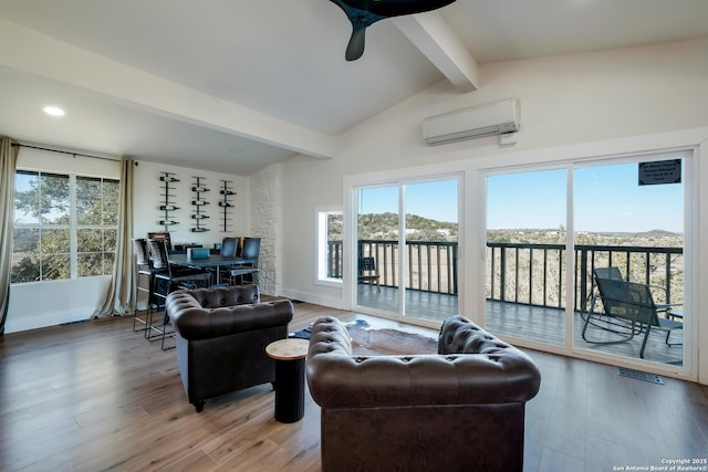 living room with wood finished floors, visible vents, baseboards, vaulted ceiling with beams, and a wall mounted air conditioner