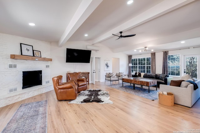 living room with visible vents, lofted ceiling with beams, a wall mounted AC, and ceiling fan