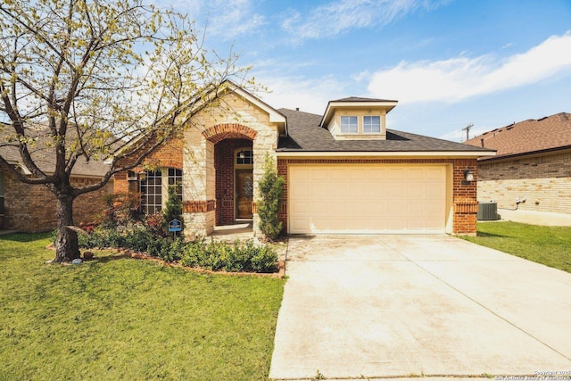 view of front of home with driveway, stone siding, a front yard, a garage, and brick siding