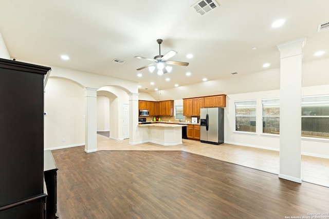 26823 Rustic Brk, San Antonio, TX 78261 - kitchen featuring visible vents, appliances with stainless steel finishes, brown cabinetry, decorative columns, and ceiling fan