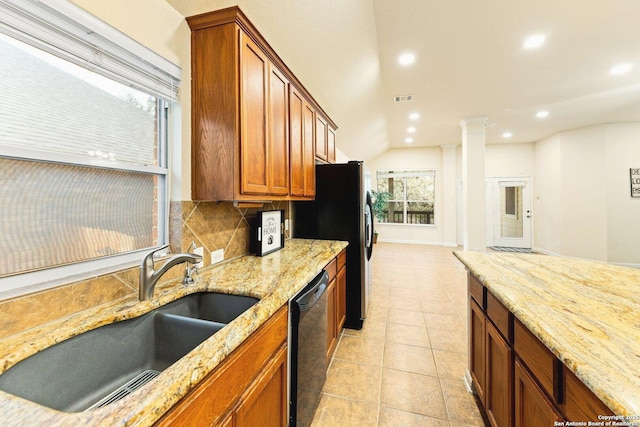 26823 Rustic Brk, San Antonio, TX 78261 - kitchen with a sink, light stone counters, black dishwasher, decorative backsplash, and ornate columns