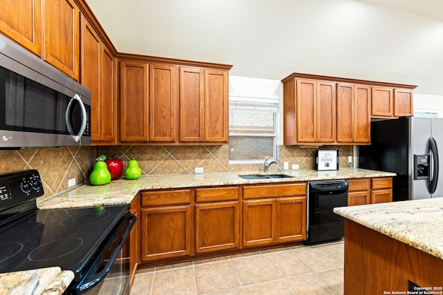 26823 Rustic Brk, San Antonio, TX 78261 - kitchen featuring brown cabinetry, decorative backsplash, black appliances, and a sink