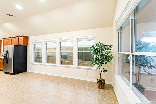 26823 Rustic Brk, San Antonio, TX 78261 - kitchen featuring refrigerator with ice dispenser, a healthy amount of sunlight, visible vents, and brown cabinets