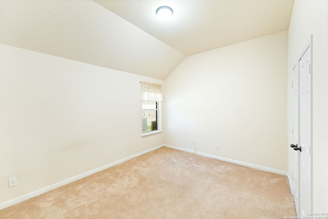 26823 Rustic Brk, San Antonio, TX 78261 - spare room with lofted ceiling, light colored carpet, and baseboards