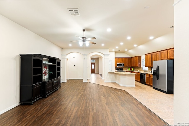 26823 Rustic Brk, San Antonio, TX 78261 - kitchen featuring visible vents, backsplash, brown cabinets, appliances with stainless steel finishes, and arched walkways