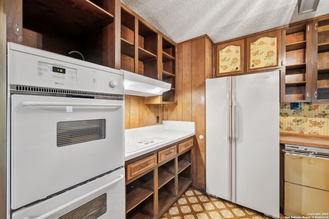 10103 Northampton, San Antonio, TX 78230 - kitchen featuring white appliances, open shelves, light countertops, under cabinet range hood, and brown cabinetry