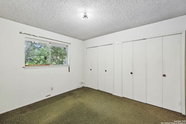 10103 Northampton, San Antonio, TX 78230 - unfurnished bedroom featuring two closets, a textured ceiling, carpet floors, and baseboards