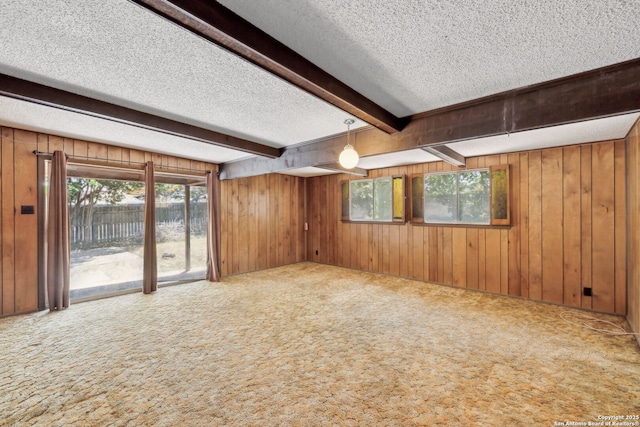 10103 Northampton, San Antonio, TX 78230 - empty room with carpet flooring, beam ceiling, a textured ceiling, and wooden walls