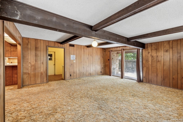 10103 Northampton, San Antonio, TX 78230 - carpeted spare room featuring a textured ceiling, wood walls, and beam ceiling