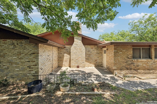10103 Northampton, San Antonio, TX 78230 - doorway to property featuring a patio area and brick siding