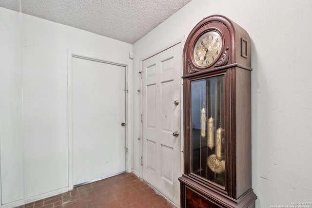 10103 Northampton, San Antonio, TX 78230 - hall featuring a textured ceiling and brick patterned floors