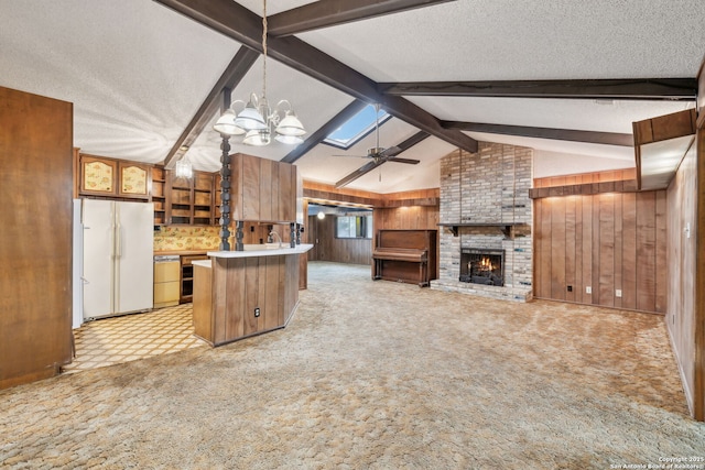 10103 Northampton, San Antonio, TX 78230 - kitchen with freestanding refrigerator, wooden walls, a chandelier, light carpet, and open floor plan