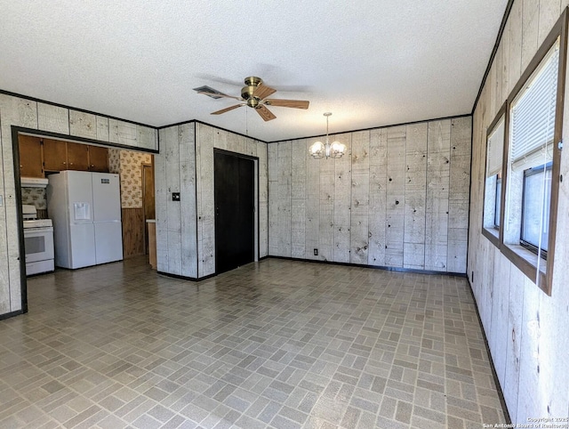 spare room featuring visible vents, brick patterned floor, a textured ceiling, and ceiling fan with notable chandelier