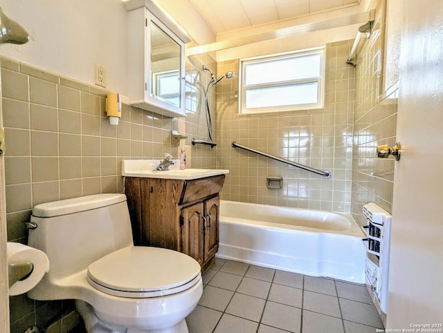full bath featuring vanity, washtub / shower combination, tile walls, toilet, and tile patterned floors
