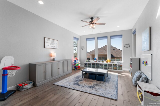 interior space featuring wood finished floors, recessed lighting, a ceiling fan, and baseboards
