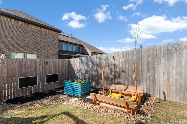 view of yard featuring a vegetable garden and fence