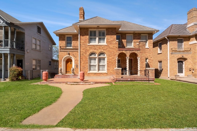 243 E Lullwood, San Antonio, TX 78212 - view of front of home featuring a front yard, brick siding, a balcony, and a chimney