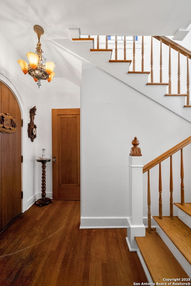 243 E Lullwood, San Antonio, TX 78212 - foyer with arched walkways, stairway, baseboards, and wood finished floors