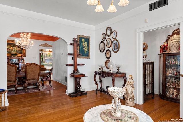 243 E Lullwood, San Antonio, TX 78212 - interior space with baseboards, an inviting chandelier, visible vents, arched walkways, and wood finished floors