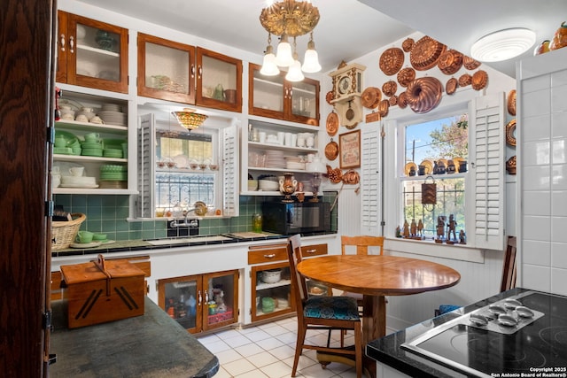 243 E Lullwood, San Antonio, TX 78212 - kitchen featuring tile counters, light tile patterned floors, backsplash, black appliances, and a sink