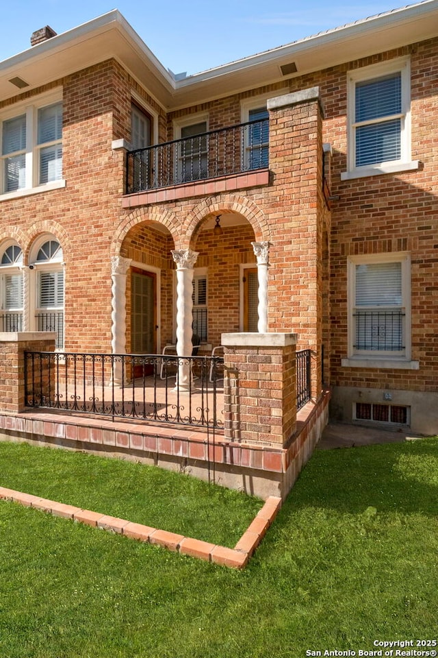 243 E Lullwood, San Antonio, TX 78212 - back of house featuring a balcony and brick siding