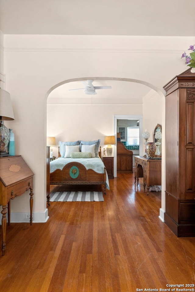 243 E Lullwood, San Antonio, TX 78212 - bedroom with arched walkways and wood finished floors