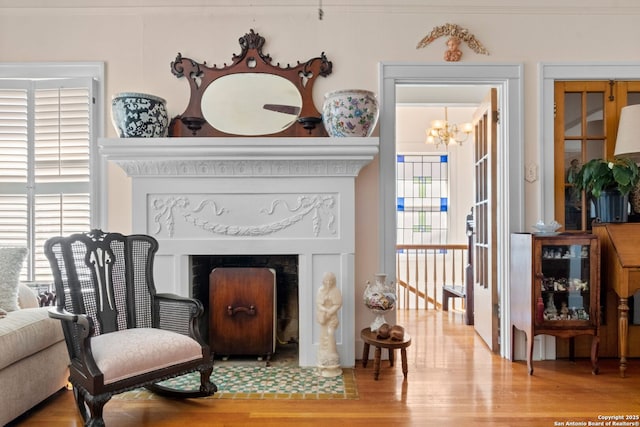 243 E Lullwood, San Antonio, TX 78212 - living area featuring wood finished floors, a chandelier, a fireplace with flush hearth, and a healthy amount of sunlight