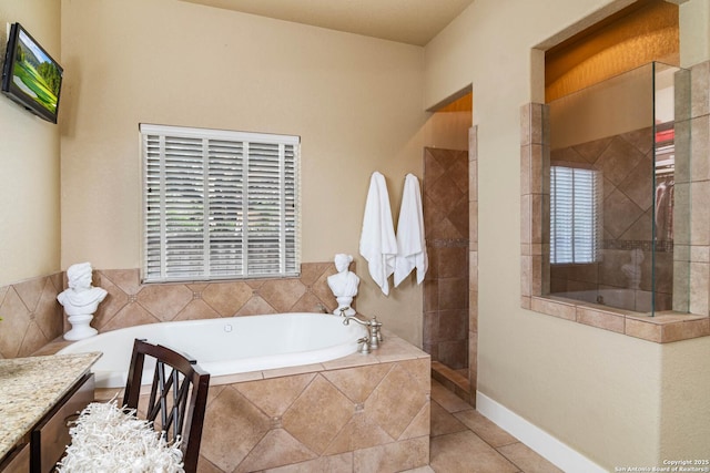 full bath featuring walk in shower, a garden tub, vanity, and tile patterned flooring