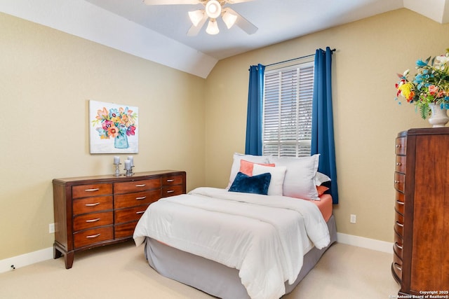 bedroom with a ceiling fan, baseboards, vaulted ceiling, and light carpet