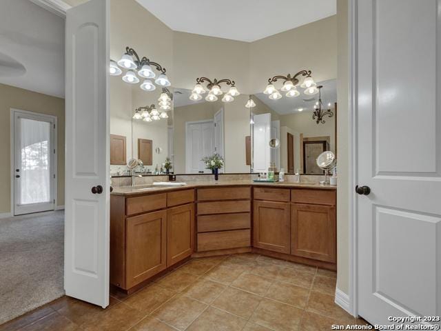 1236 Primrose Path, Canyon Lake, TX 78133 - full bath with double vanity, tile patterned floors, and a chandelier