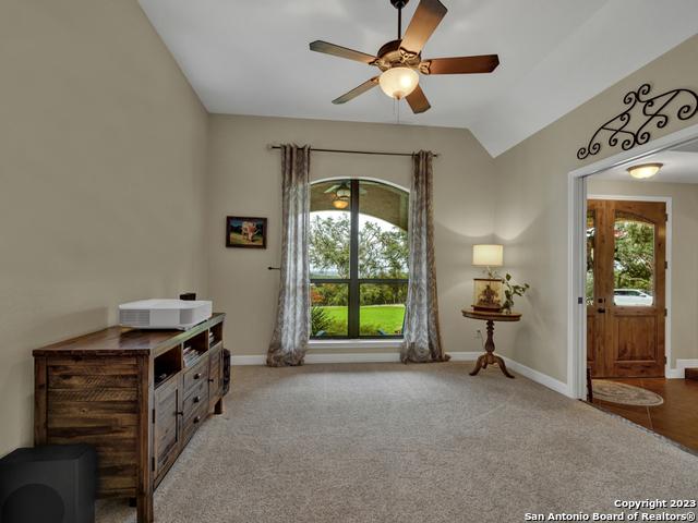 1236 Primrose Path, Canyon Lake, TX 78133 - living area with lofted ceiling, carpet flooring, baseboards, and ceiling fan