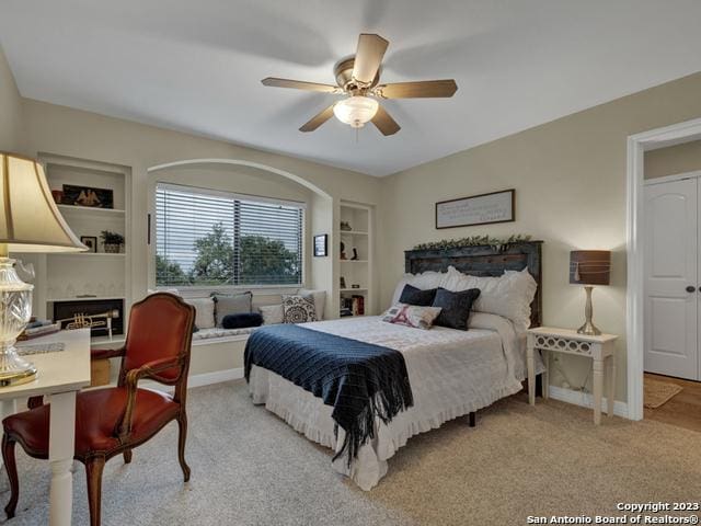 1236 Primrose Path, Canyon Lake, TX 78133 - bedroom with baseboards, light carpet, and ceiling fan