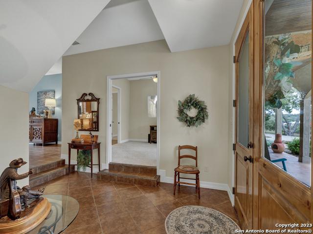 1236 Primrose Path, Canyon Lake, TX 78133 - foyer with dark tile patterned flooring and baseboards