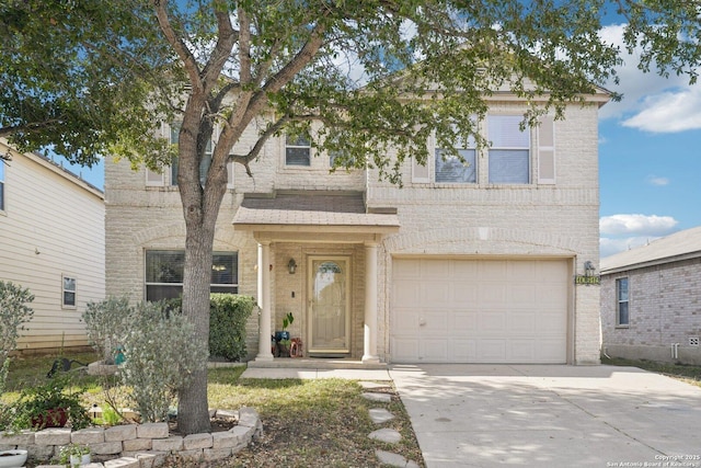 traditional-style home featuring a garage, concrete driveway, and brick siding