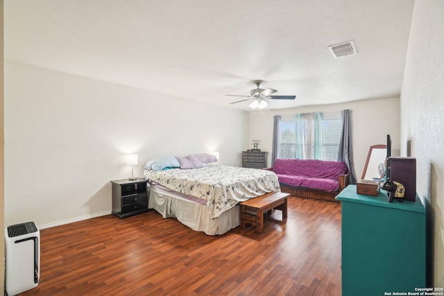 bedroom with dark wood-style flooring, baseboards, a ceiling fan, and visible vents
