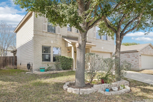 view of front of property featuring a garage, brick siding, driveway, and fence