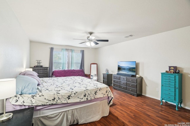 bedroom with visible vents, ceiling fan, baseboards, and dark wood finished floors