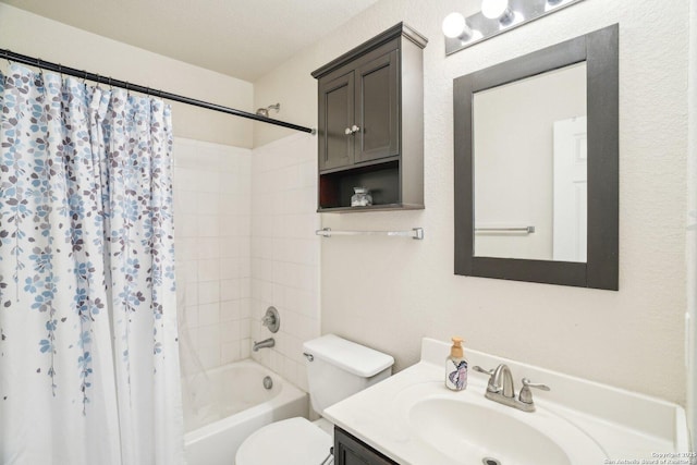 bathroom featuring toilet, shower / bath combo with shower curtain, and vanity