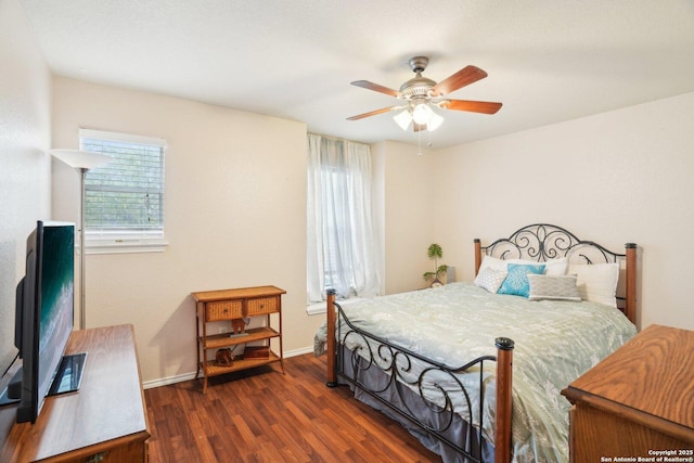 bedroom featuring baseboards, a ceiling fan, and wood finished floors